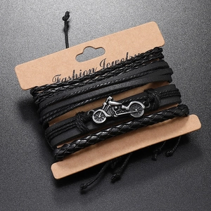 Detail shot of multi-layer braided leather bracelet set with retro silver motorcycle charm