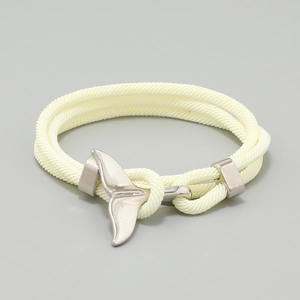Detail of nautical braided cream rope bracelet featuring silver whale tail metal buckle