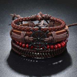 Detail of four-piece vintage nautical men's leather bracelets with anchor charm