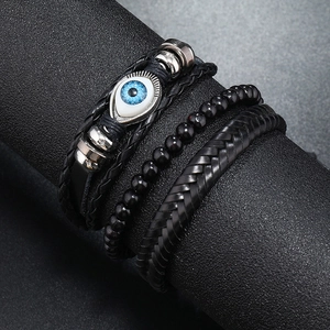 Three-piece black leather and beaded bracelet set featuring blue Evil Eye charm and metal beads