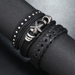 Three-piece black layered leather bracelet set featuring star charms and silver metal studs