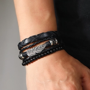 Men's 3-piece set featuring braided leather bands, silver feather charm, and black beads