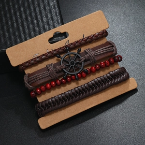 Detail of four-piece men's vintage leather bracelet set with rudder charm and wood beads