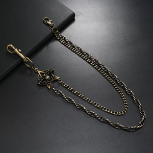 Double-layered punk metal pants chain with star pendant on a black textured background