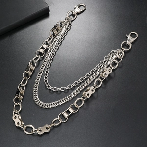 Detailed view of triple-layered silver punk waist chain with lobster clasps on black surface