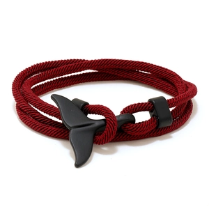 Minimalist red woven nautical bracelet featuring a matte black whale tail buckle clasp