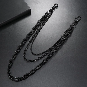 Three-layer black punk metal pants chain with lobster clasps on a dark textured background