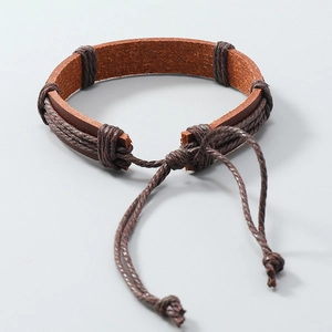Detail of a brown woven leather bracelet with adjustable drawstring closure and handmade knots