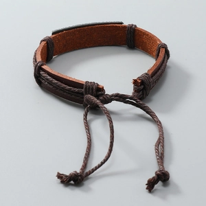 Detail of hand-woven brown leather bracelet with adjustable cords and rustic finish