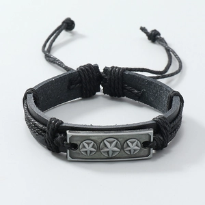 Detail of adjustable woven leather bracelet with vintage silver star metal plate
