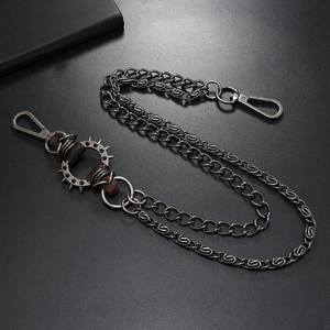 Detail of gunmetal punk pants chain with spiked ring and leather wrap accents