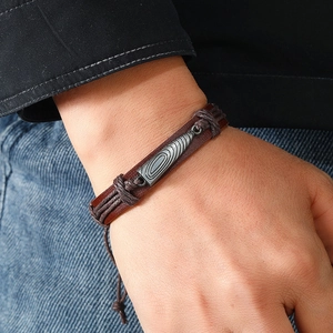 Handmade woven dark brown leather bracelet with industrial style grey metal ornament