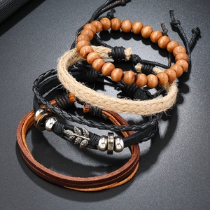 Detailed macro view of four-piece vintage men's woven leather bracelets with wooden beads
