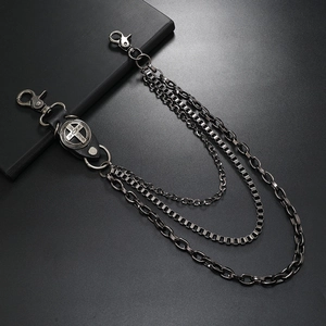 Detail of dark gunmetal multi-layer hip hop pants chain with leather cross accent