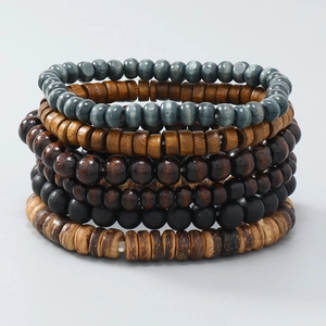 Detail of 6-piece bohemian stackable bracelets with natural wood beads on elastic cord