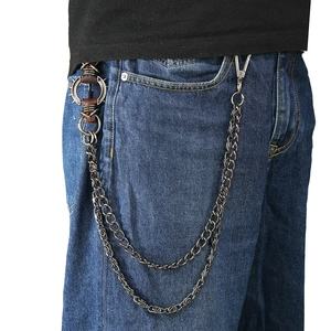 Punk style multi-layer metal trousers chain with spikes and leather on blue jeans
