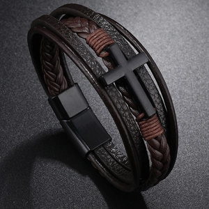 Detailed view of multilayer woven leather bracelet with cross and magnetic clasp