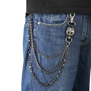 Punk style multi-layer metal wallet chain with leather cross patch on denim jeans