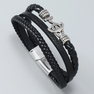 Detail of multi-layer braided leather bracelet with vintage silver anchor charm and clasp