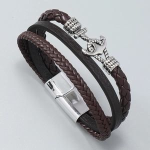 Detailed view of the vintage nautical anchor and silver magnetic clasp on leather bracelet