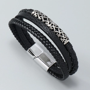 Detailed close-up of multilayer braided leather bracelet with engraved silver metal tube