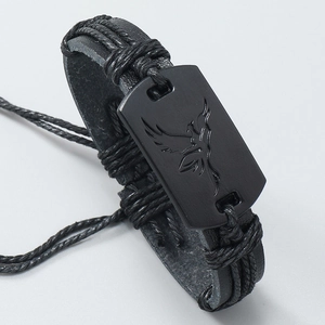 Detail of hand-woven black leather bracelet for men with matte eagle totem charm