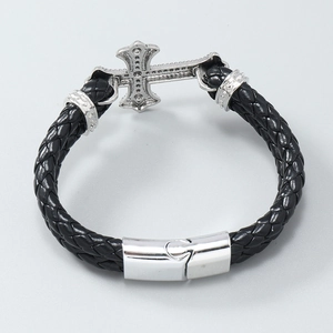 Detail of woven black leather men's bracelet with silver cross and magnetic buckle
