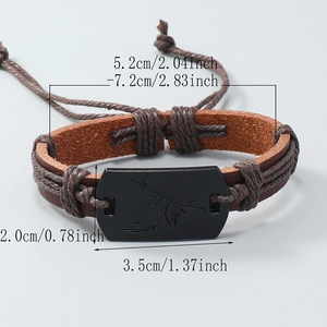 Adjustable woven leather bracelet featuring an engraved bird motif on a matte metal plate