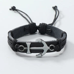 Close-up of handmade nautical leather bracelet featuring a silver metal anchor clasp