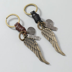 Vintage leather keychain set with antique bronze wing charms and engraved plaques