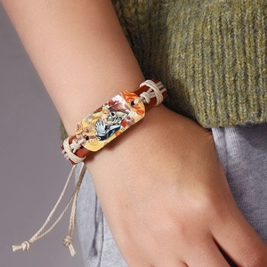 Bohemian adjustable leather bracelet with colorful skull totem and woven cord detail