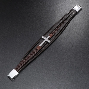 Detail of multi-layer braided brown leather bracelet with silver cross and magnetic clasp