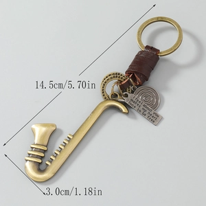 Retro saxophone keychain in bronze alloy with woven leather and engraved round charm
