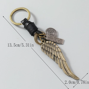 Handmade vintage leather keychain with bronze feather wing charm and engraved pendant