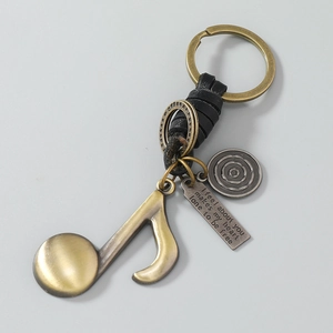 Retro bronze music note keychain with black leather loop and inspirational quote tag