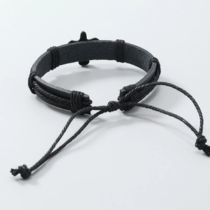 Detail of adjustable black woven leather bracelet featuring a metal cross charm for men