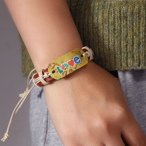 Handmade multilayer leather bracelet with retro LOVE metal plate on model's wrist