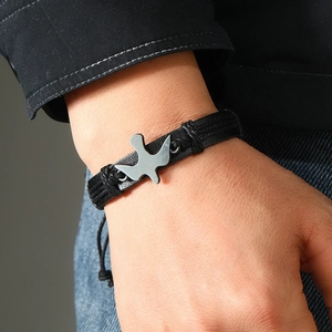 Men's minimalist braided leather bracelet with silver bird charm and adjustable cord