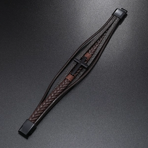 Detail of dark brown multilayer braided leather bracelet with black matte cross and magnetic clasp
