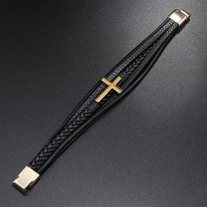 Detail view of multi-layer braided leather bracelet with golden cross and magnetic clasp