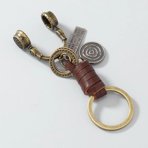 Vintage bronze headphone keychain with woven brown leather and engraved charms