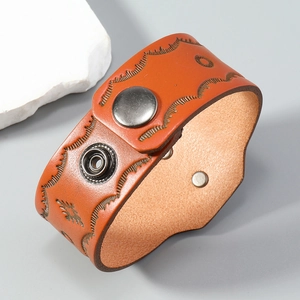 Bohemian retro wide leather bracelet with embossed patterns and silver snap buttons