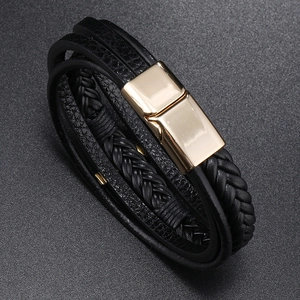 Macro shot of multilayer black leather bracelet with elegant gold magnetic clasp detail