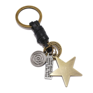 Vintage braided leather keychain with star pendant and engraved metal charms on white base