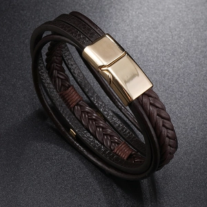 Close-up of brown multilayer braided leather bracelet with golden magnetic clasp