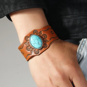 Bohemian vintage brown leather wide bracelet featuring a turquoise stone and embossed patterns