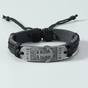 Detailed view of woven leather anchor bracelet featuring engraved Brave metal charm