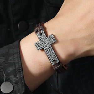 Men's retro braided leather bracelet featuring a textured vintage metal cross charm