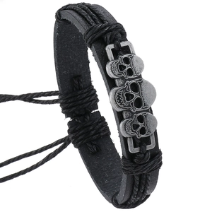 Pulsera de cuero hecha a mano para hombre con tres calaveras de plata vintage y cuerda tejida