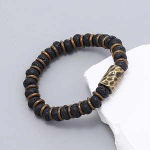 Retro handmade beaded bracelet with black lava stones and textured bronze metal accents